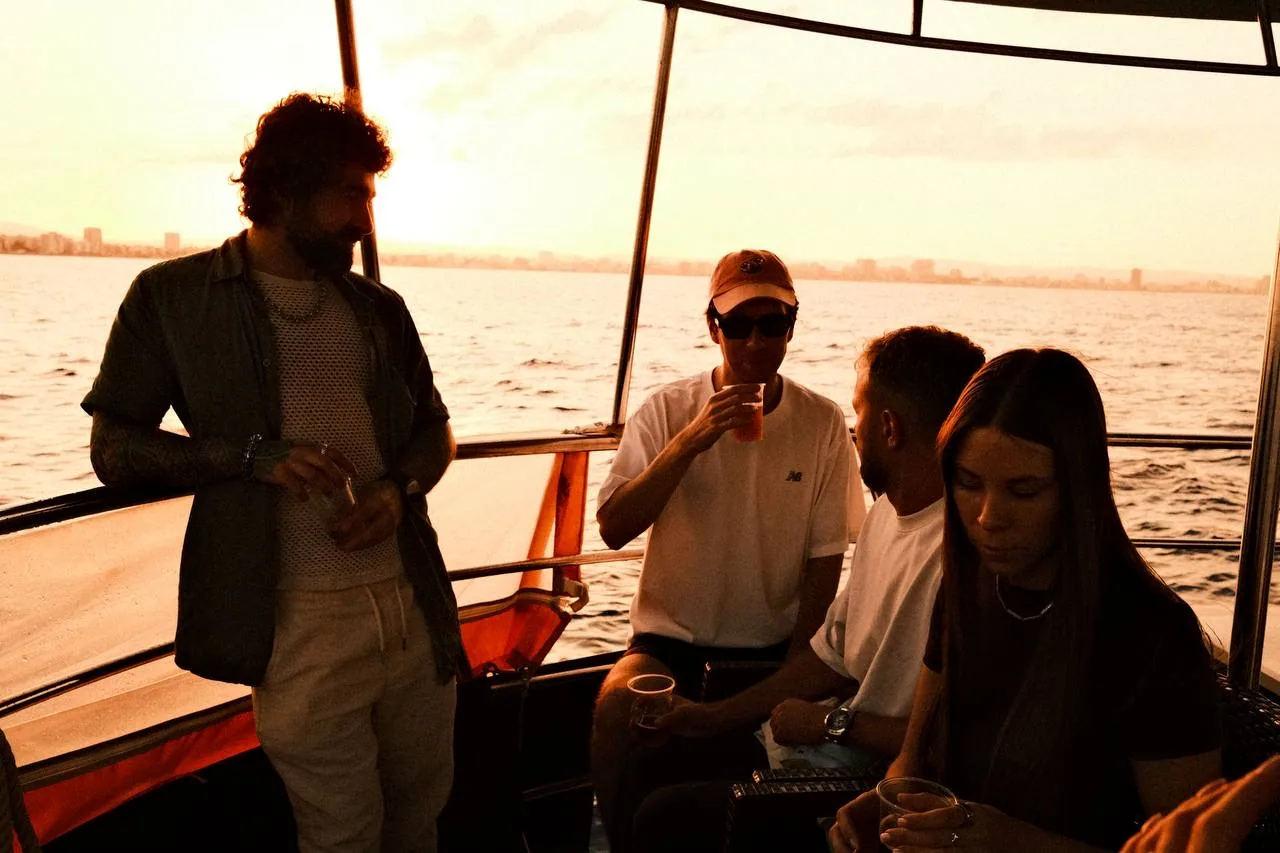 With the team on a boat at sunset